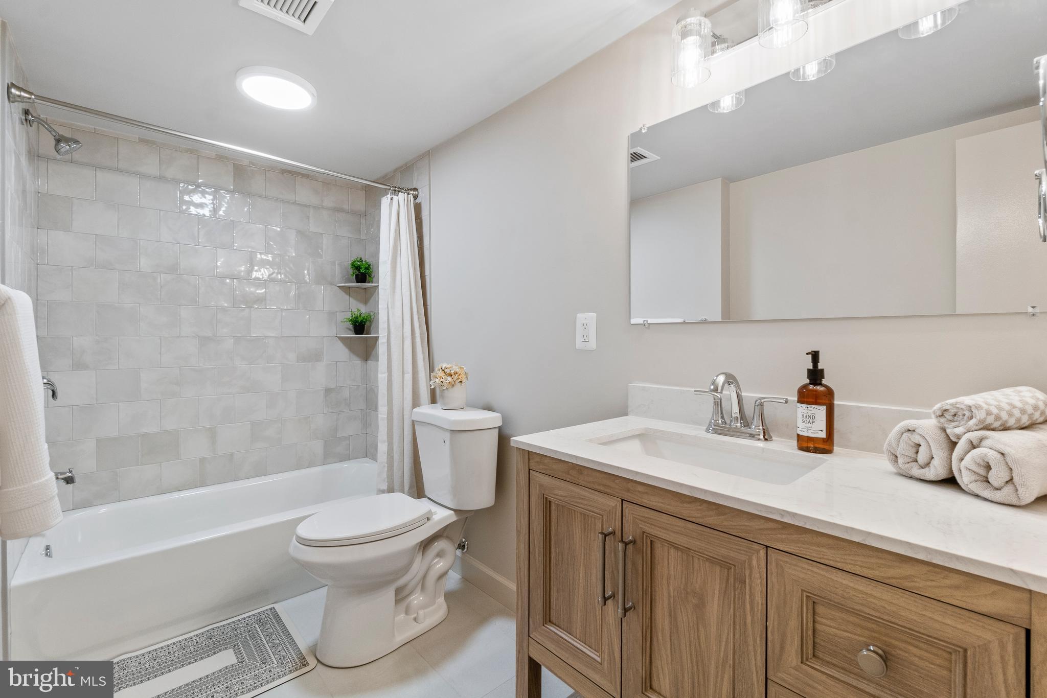 205 East Joppa Road, Unit 2703 Towson, MD 21286 - Photo 24 of 34 a bathroom with a sink a toilet and shower