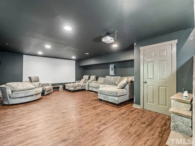a bedroom with furniture and a wooden floor
