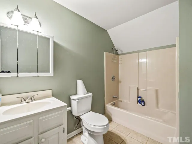 a bathroom with a sink a toilet and a large mirror