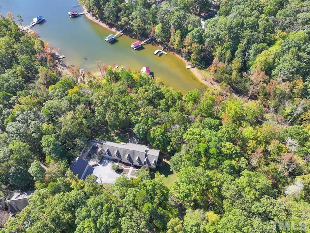 an aerial view of a house with a yard basket ball court and outdoor seating