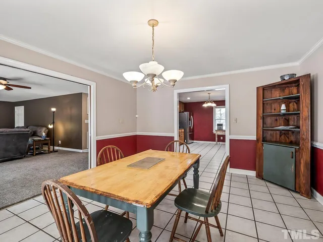 a view of a dining room with furniture and chandelier