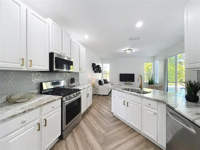 a large kitchen with a stove top oven
