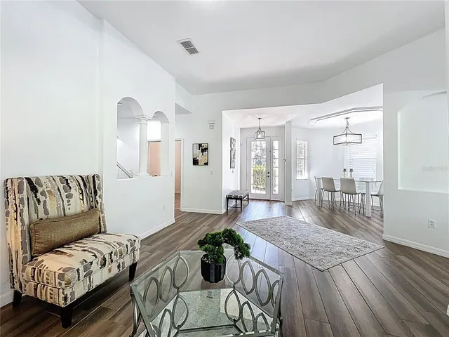 a living room with furniture and wooden floor