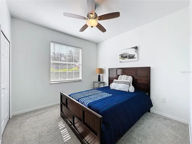 a bed room with a bed and a window