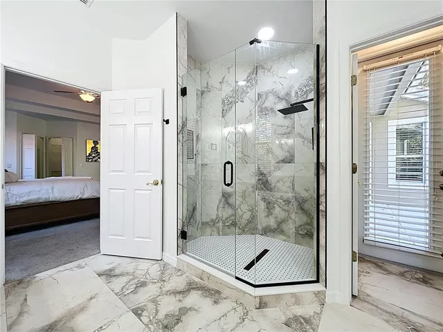 a bathroom with a shower and a bath tub