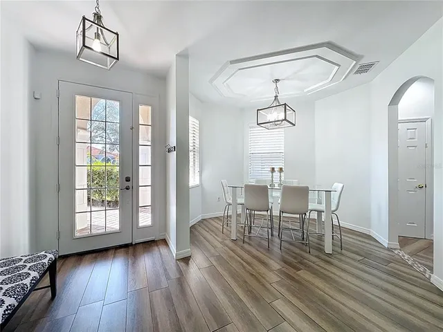 a view of a dining room with furniture window and wooden floor
