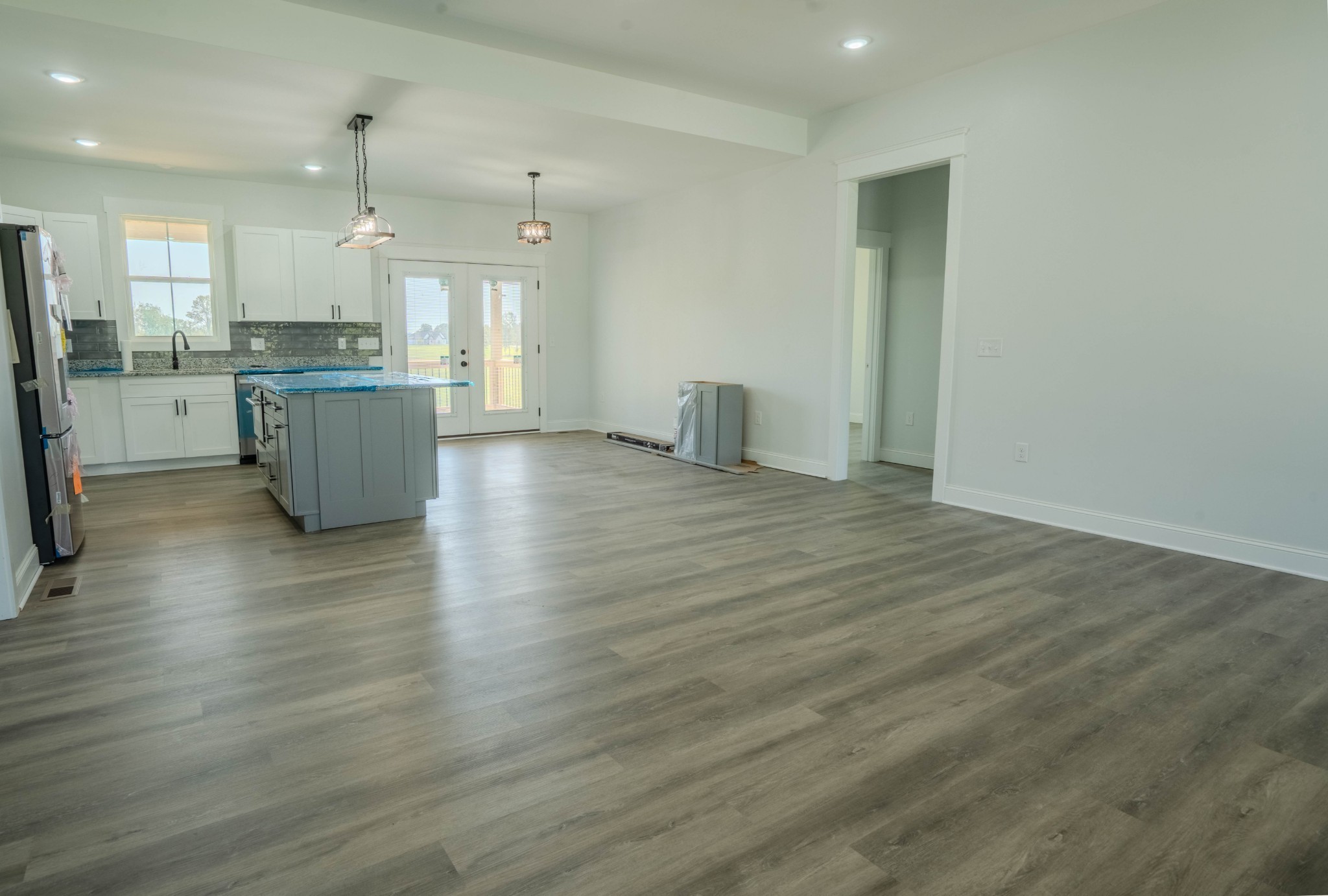 0 Beartown Road Loretto, TN 38469 - Photo 17 of 46 a kitchen with stainless steel appliances granite countertop a sink a stove a refrigerator and island with wooden floor