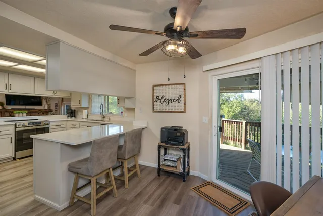 a kitchen with a table chairs refrigerator and cabinets