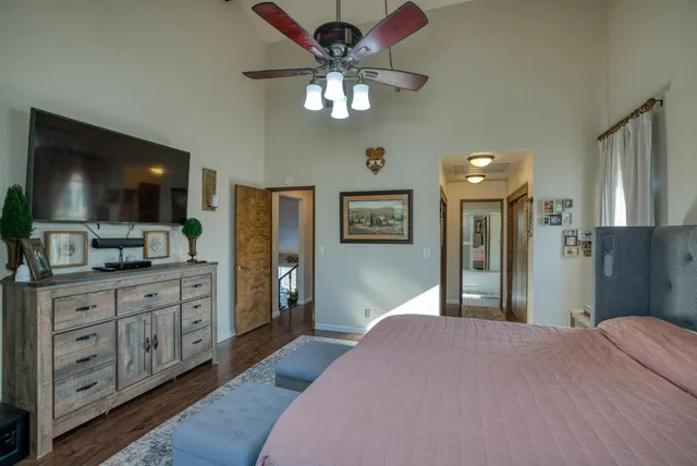 a bedroom with chandelier and mirror