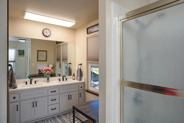 a bathroom with a double vanity sink and a mirror