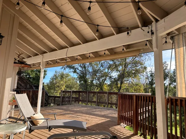 a view of balcony with wooden floor and outdoor seating