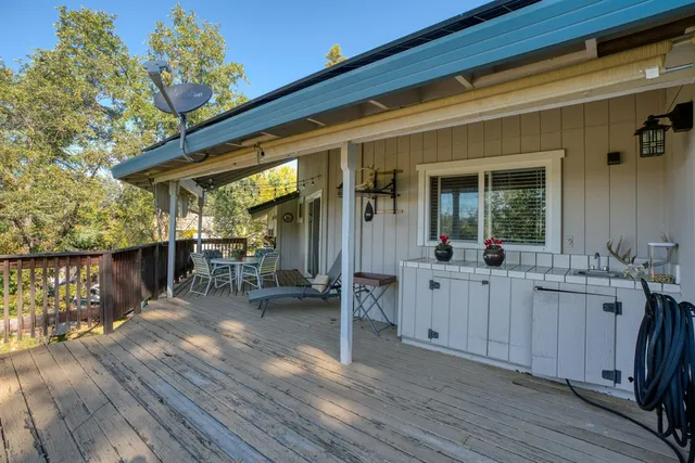 a view of a patio with table and chairs and wooden floor