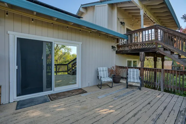 a balcony with furniture and wooden floor