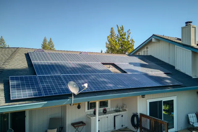 an aerial view of a house with a yard