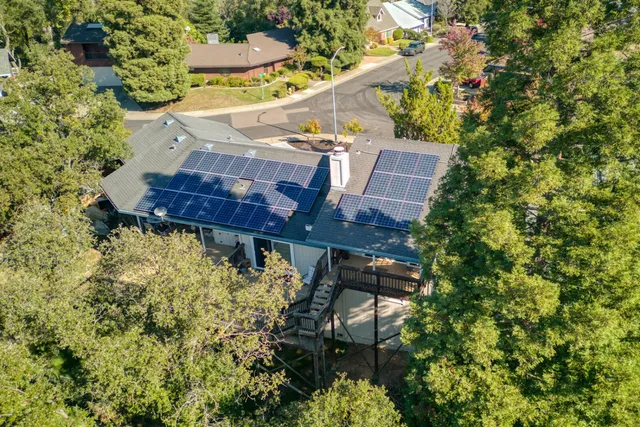 an aerial view of a house with a yard and garden