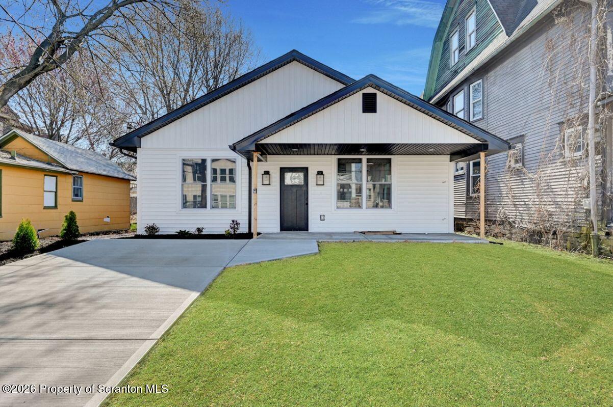 119 Prospect Avenue Scranton, PA 18505 - Photo 1 of 43 a front view of a house with a yard and garage