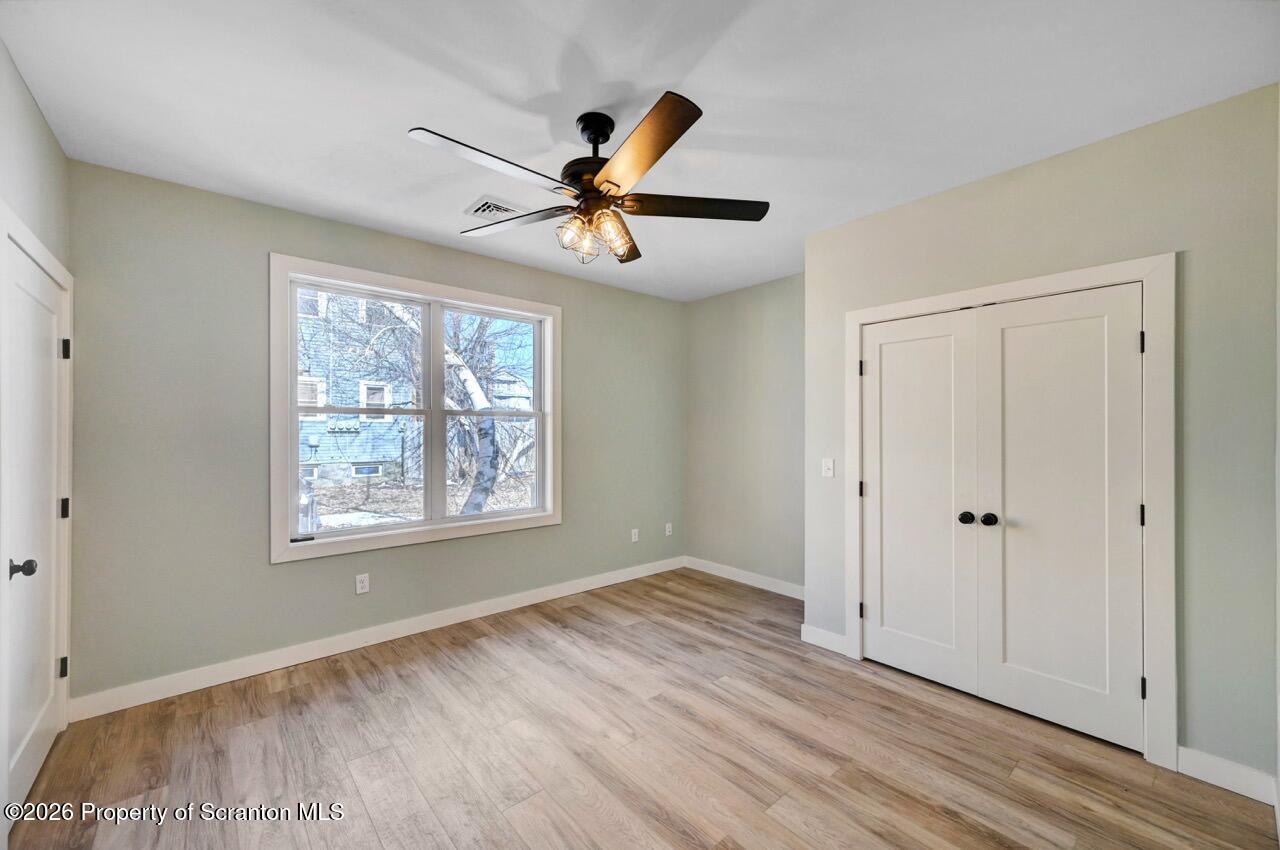 119 Prospect Avenue Scranton, PA 18505 - Photo 18 of 43 a view of an empty room with window and wooden floor