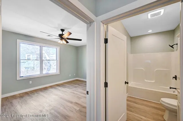 a view of a bathroom with a tub shower vanity and a sink
