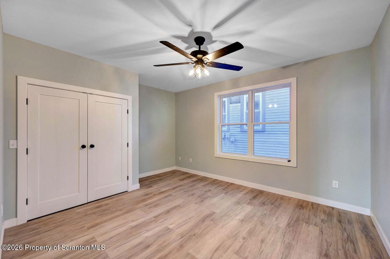119 Prospect Avenue Scranton, PA 18505 - Photo 25 of 43 a view of an empty room with window and a ceiling fan