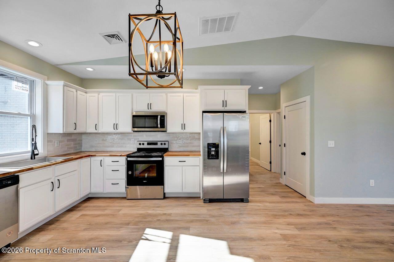 119 Prospect Avenue Scranton, PA 18505 - Photo 33 of 43 a kitchen with stainless steel appliances granite countertop a refrigerator a stove a sink and a microwave