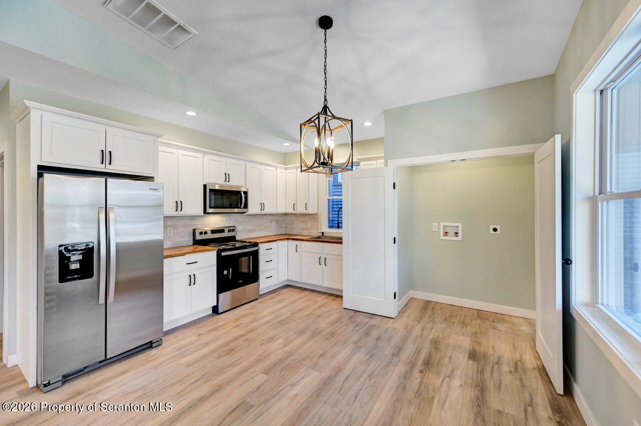 119 Prospect Avenue Scranton, PA 18505 - Photo 35 of 43 a kitchen with stainless steel appliances granite countertop a refrigerator a oven a sink dishwasher and a flat screen tv