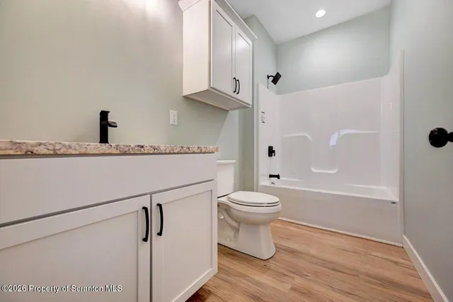 a bathroom with a toilet a sink and a bathtub