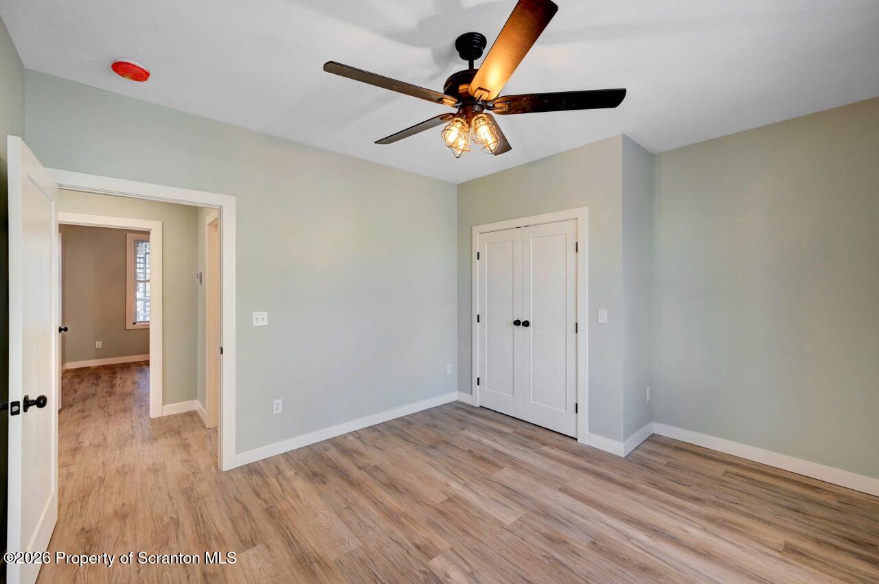 119 Prospect Avenue Scranton, PA 18505 - Photo 41 of 43 an empty room with wooden floor ceiling fan and windows