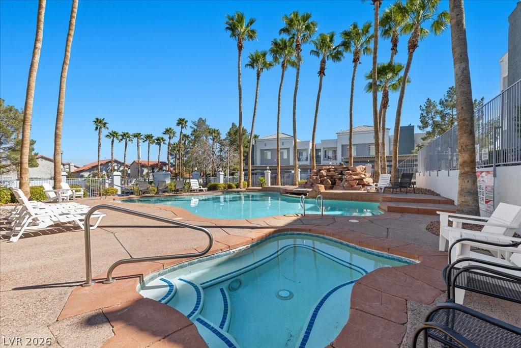 2201 Ramsgate Drive, Unit 818 Henderson, NV 89074 - Photo 28 of 32 Community pool with a patio area, a hot tub, and a residential view