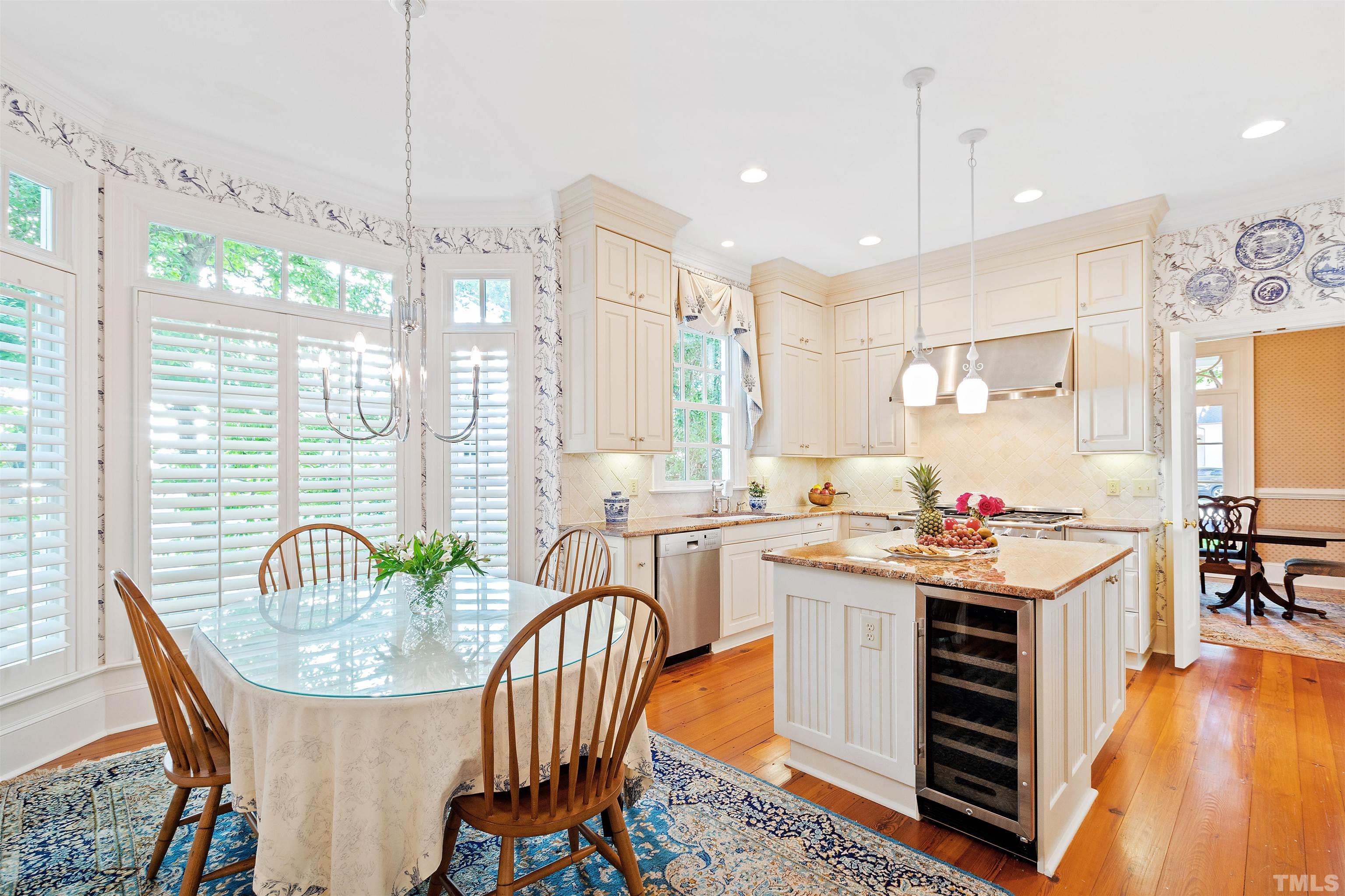 1029 Harvey Street Raleigh, NC 27608 - Photo 16 of 63 a room with stainless steel appliances granite countertop a table chairs and a view of living room