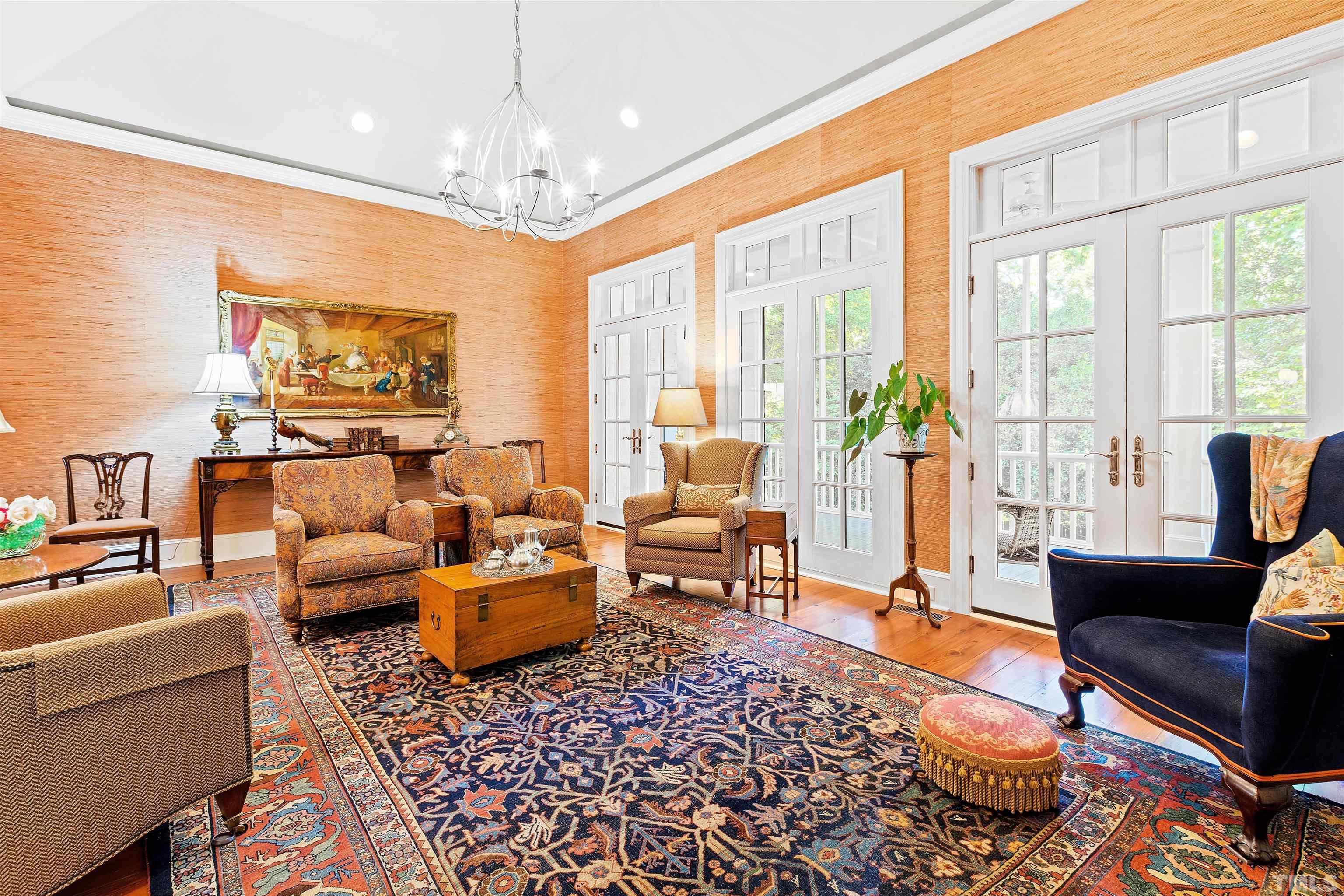 1029 Harvey Street Raleigh, NC 27608 - Photo 19 of 63 a living room with furniture and a chandelier