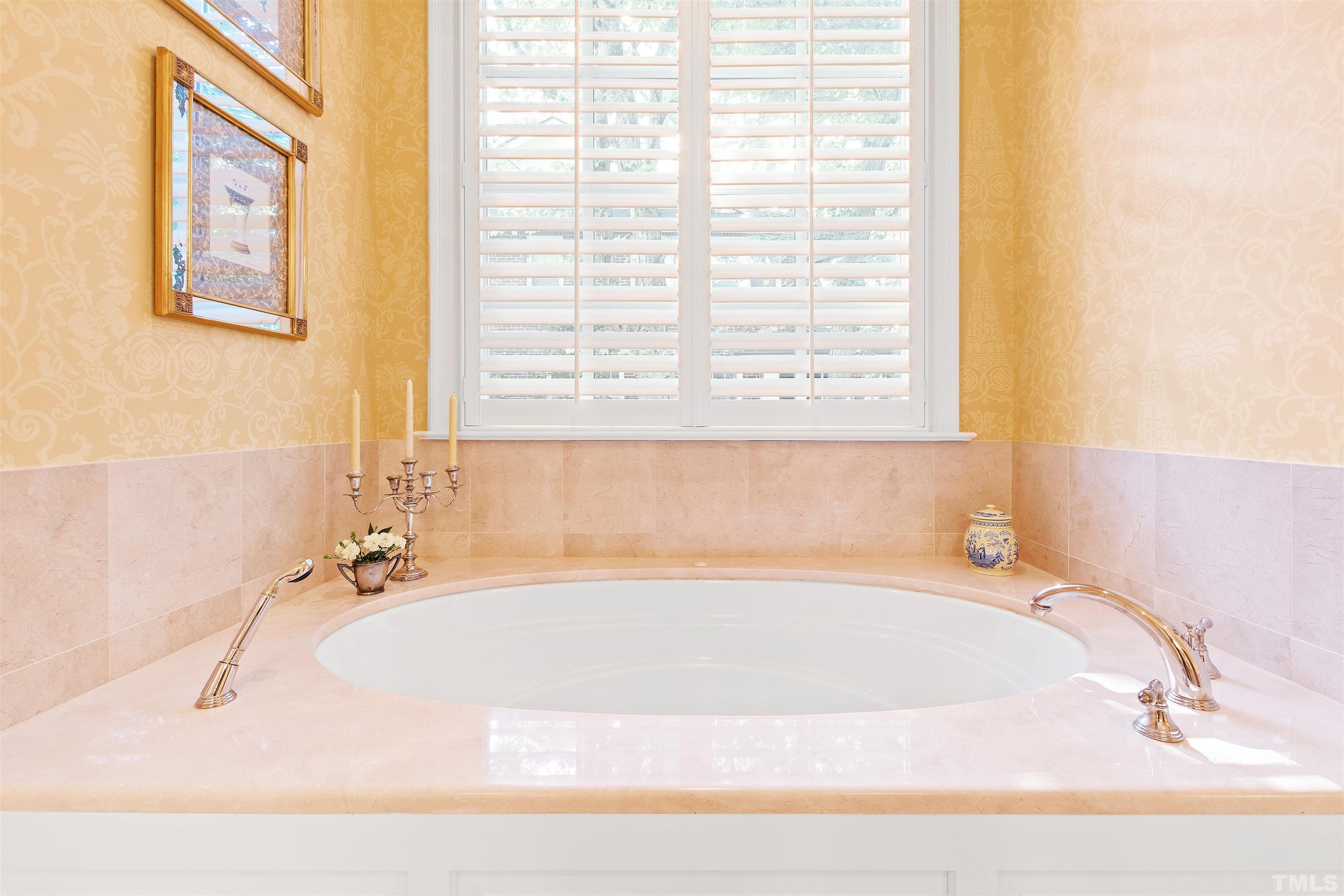 1029 Harvey Street Raleigh, NC 27608 - Photo 29 of 63 a white bath tub sitting in a bathroom next to a window