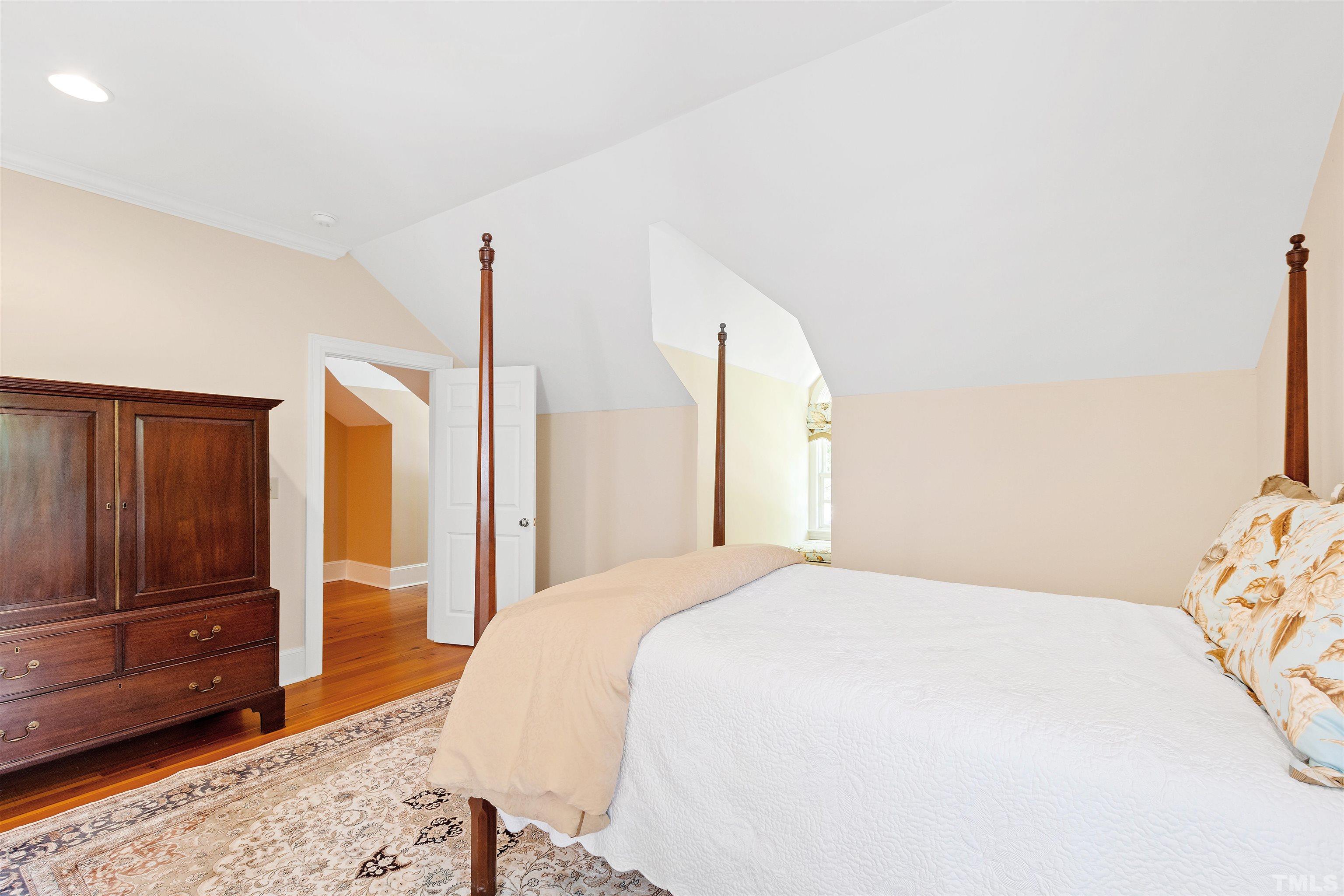 1029 Harvey Street Raleigh, NC 27608 - Photo 38 of 63 a bedroom with a bed and wooden floor