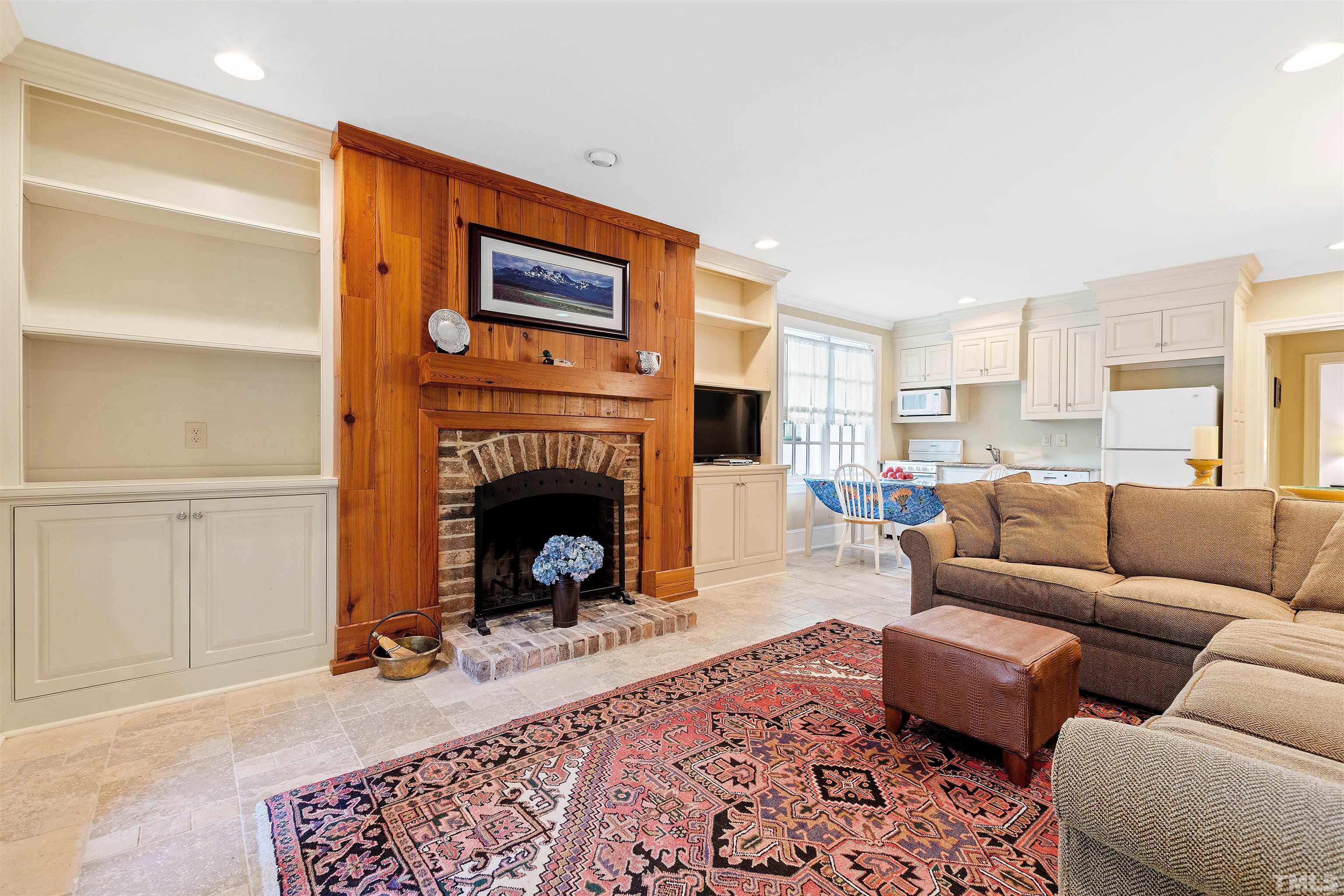 1029 Harvey Street Raleigh, NC 27608 - Photo 50 of 63 a living room with furniture and a fireplace
