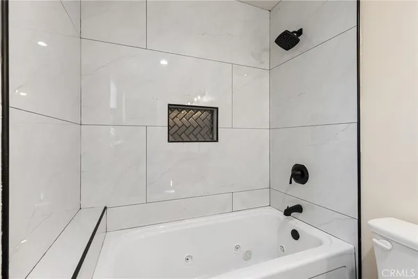 a bathroom with a bathtub and shower