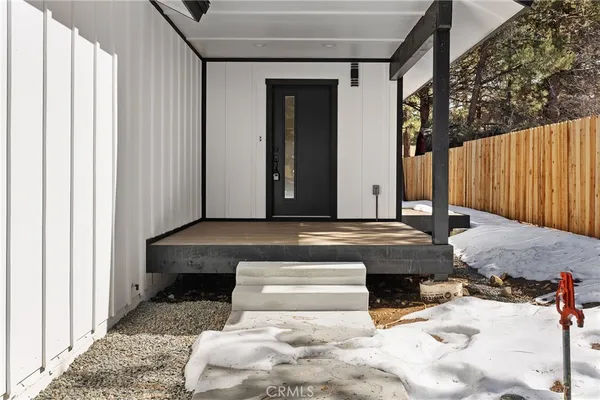 a view of a backyard with a chair and table in the patio