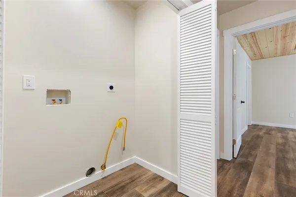 a view of a room with wooden floor and white walls