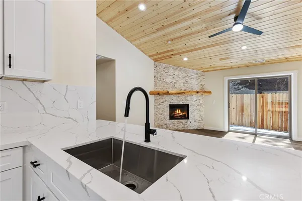 a kitchen with granite countertop a sink and cabinets
