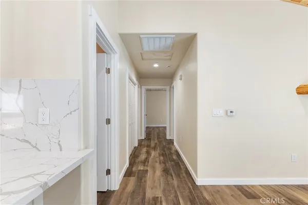 a view of a hallway with a wooden floor