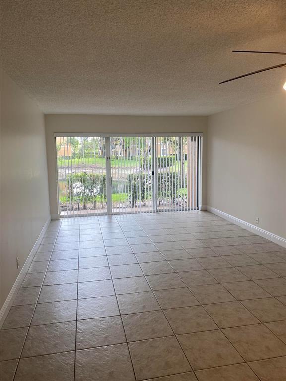 8701 Wiles Road, Unit 108 Coral Springs, FL 33067 - Photo 3 of 15 a view of an empty room and window