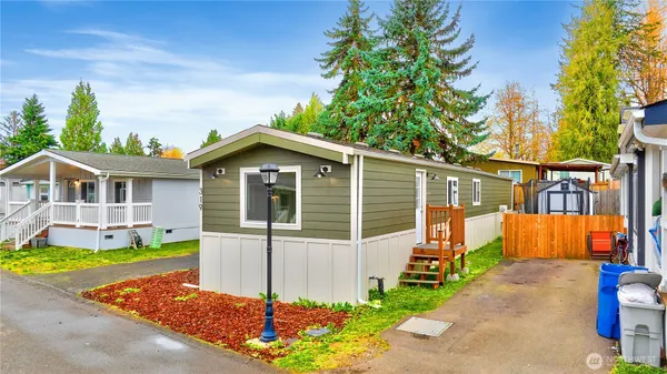 a view of a house with a yard and a garden