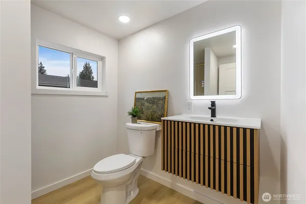 a bathroom with a toilet sink and mirror