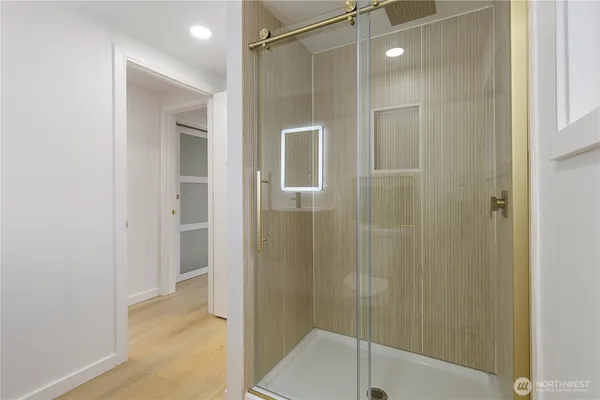a bathroom with a shower and a glass door