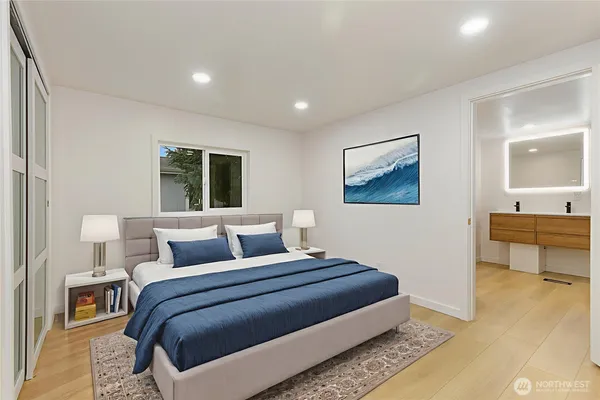 a bedroom with a large bed and a view of bathroom