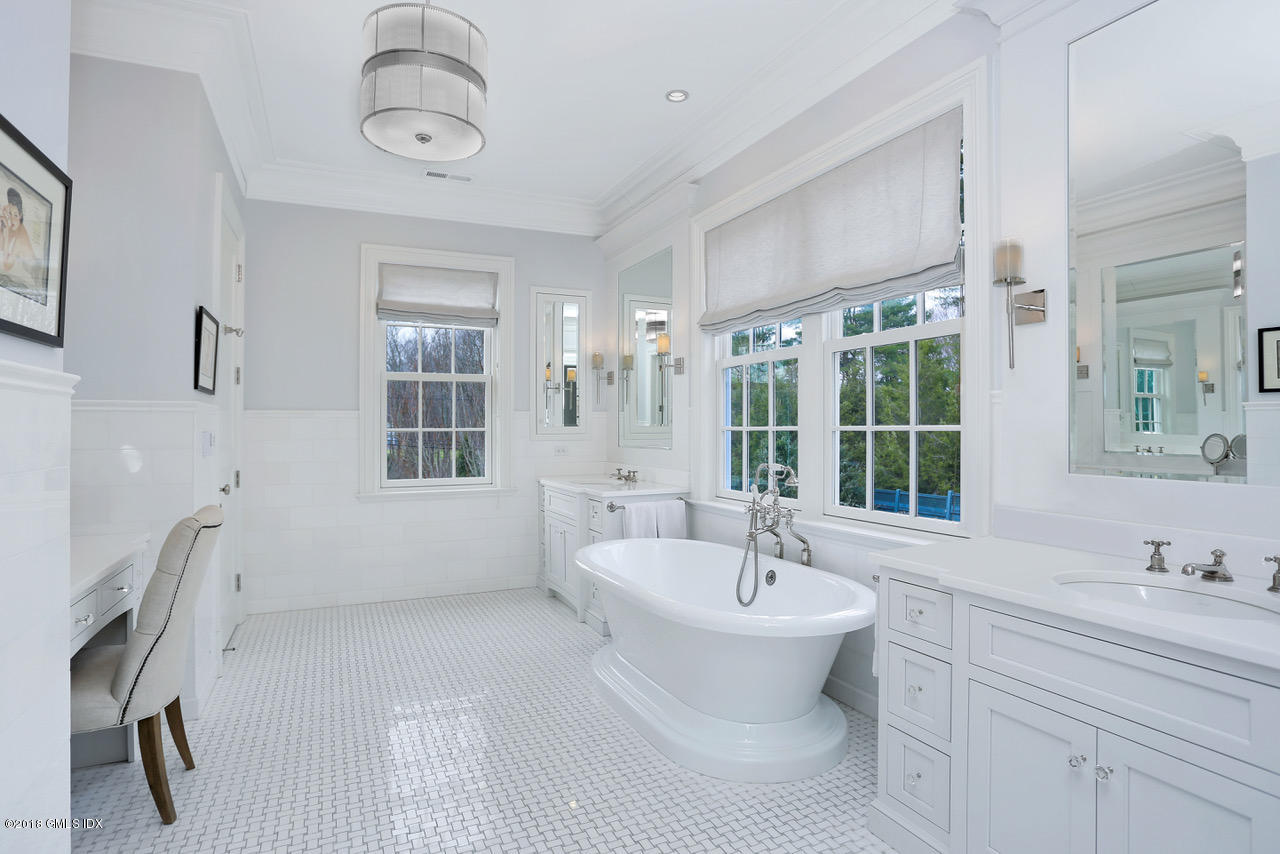 751 Lake Avenue Greenwich, CT 06830 - Photo 18 of 38 a bathroom with a sink and a large mirror