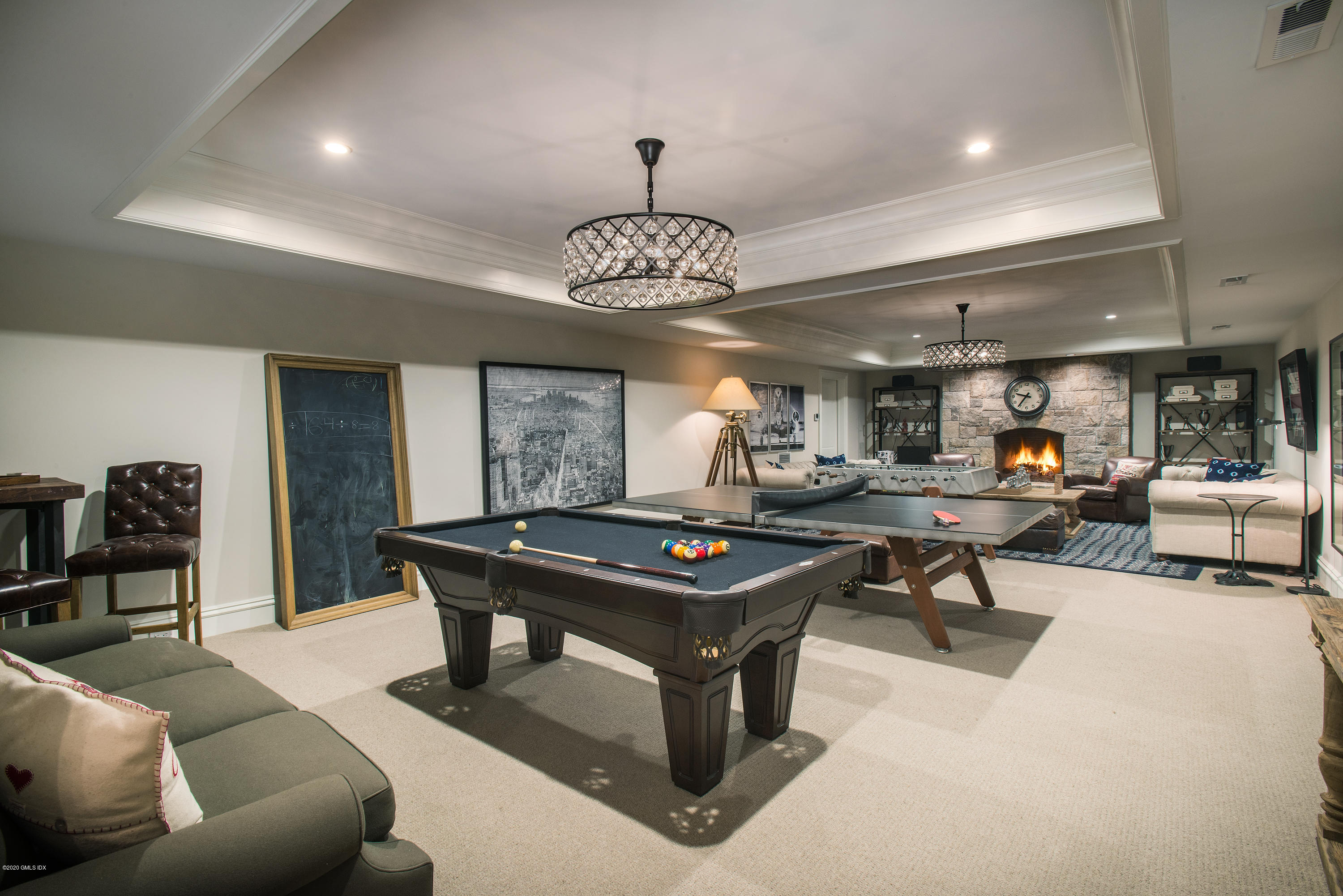 751 Lake Avenue Greenwich, CT 06830 - Photo 29 of 38 a living room with furniture a table and a chandelier