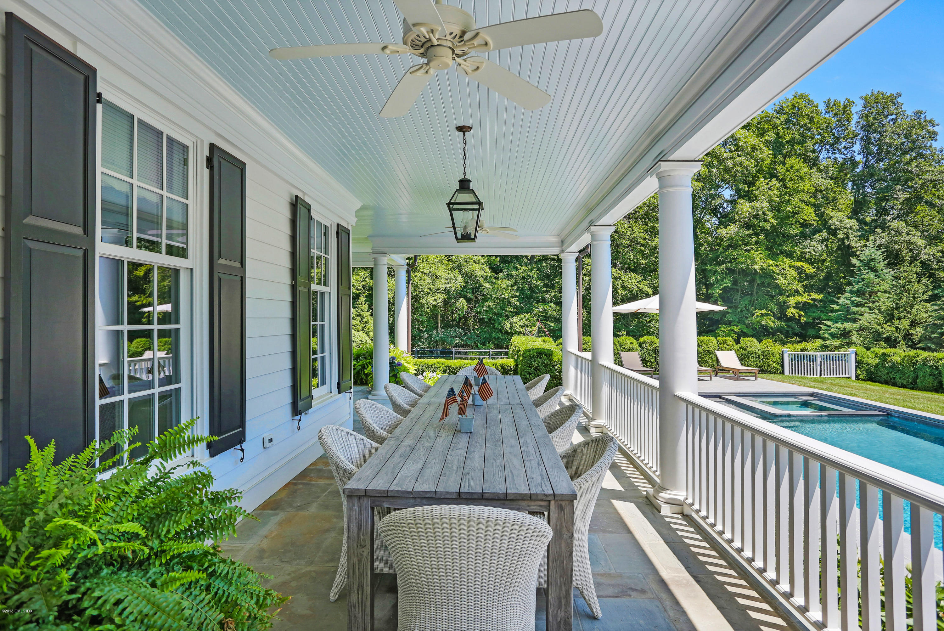 751 Lake Avenue Greenwich, CT 06830 - Photo 34 of 38 a view of a patio with a table chairs and a potted plant