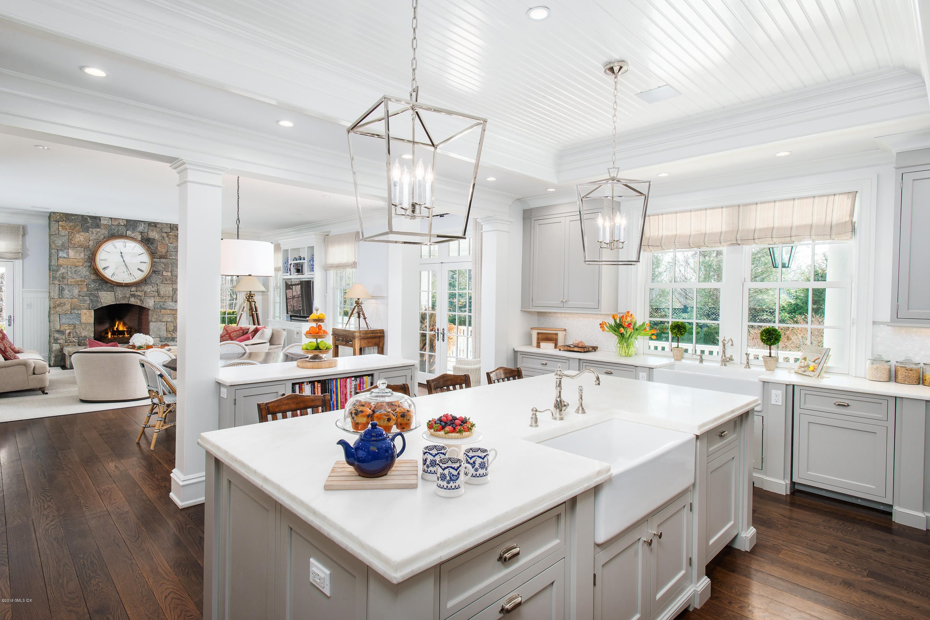 751 Lake Avenue Greenwich, CT 06830 - Photo 9 of 38 a kitchen with kitchen island white cabinets and sink