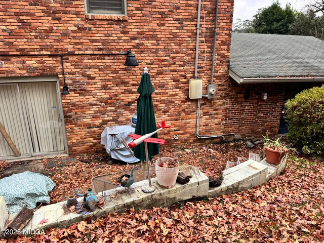 a backyard of a house with barbeque oven