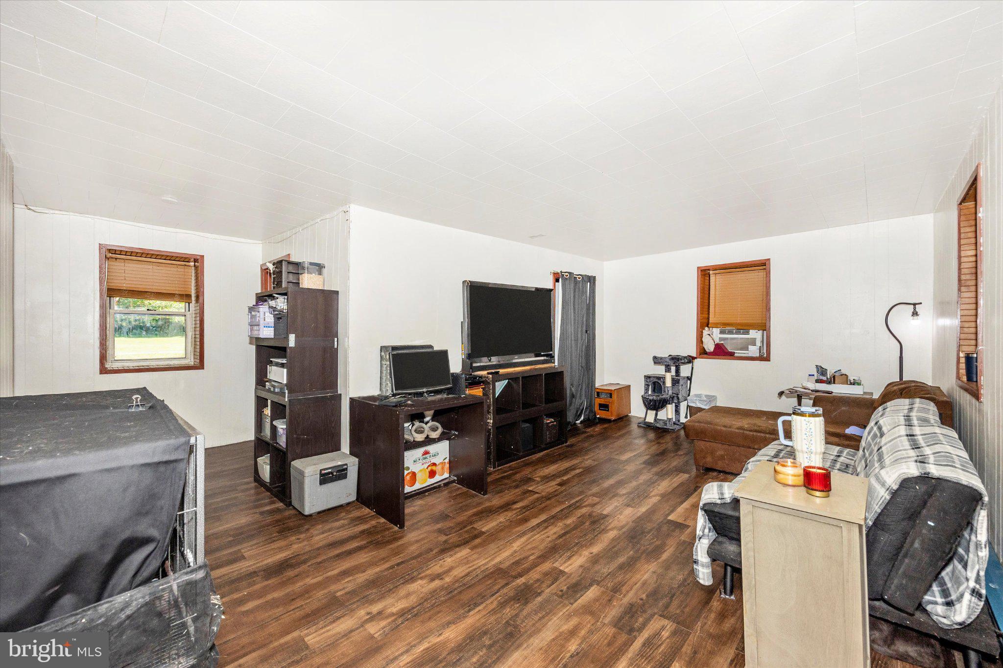 14721 Albert Staub Road Thurmont, MD 21788 - Photo 9 of 46 a living room with furniture and a flat screen tv