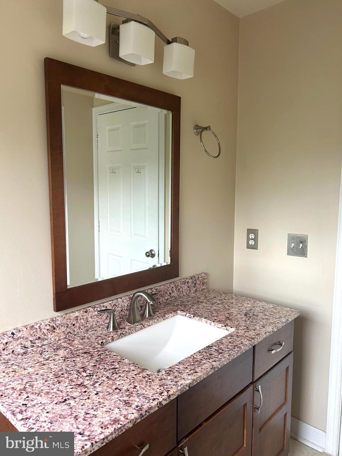 4658 Buckhorn Ridge Fairfax, VA 22030 - Photo 14 of 35 a bathroom with a granite countertop sink and a mirror